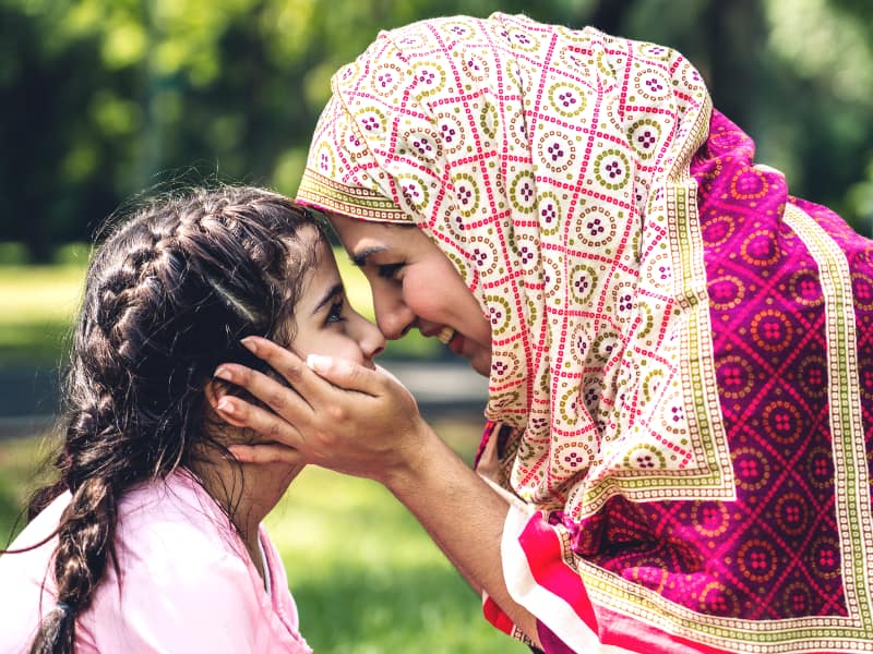 A Muslim mother holds her young daughter